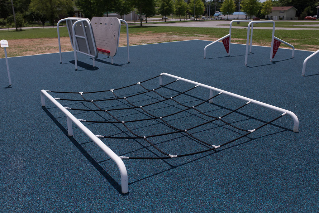 Children using the ActionFit Step Zone outdoor fitness station at a school playground