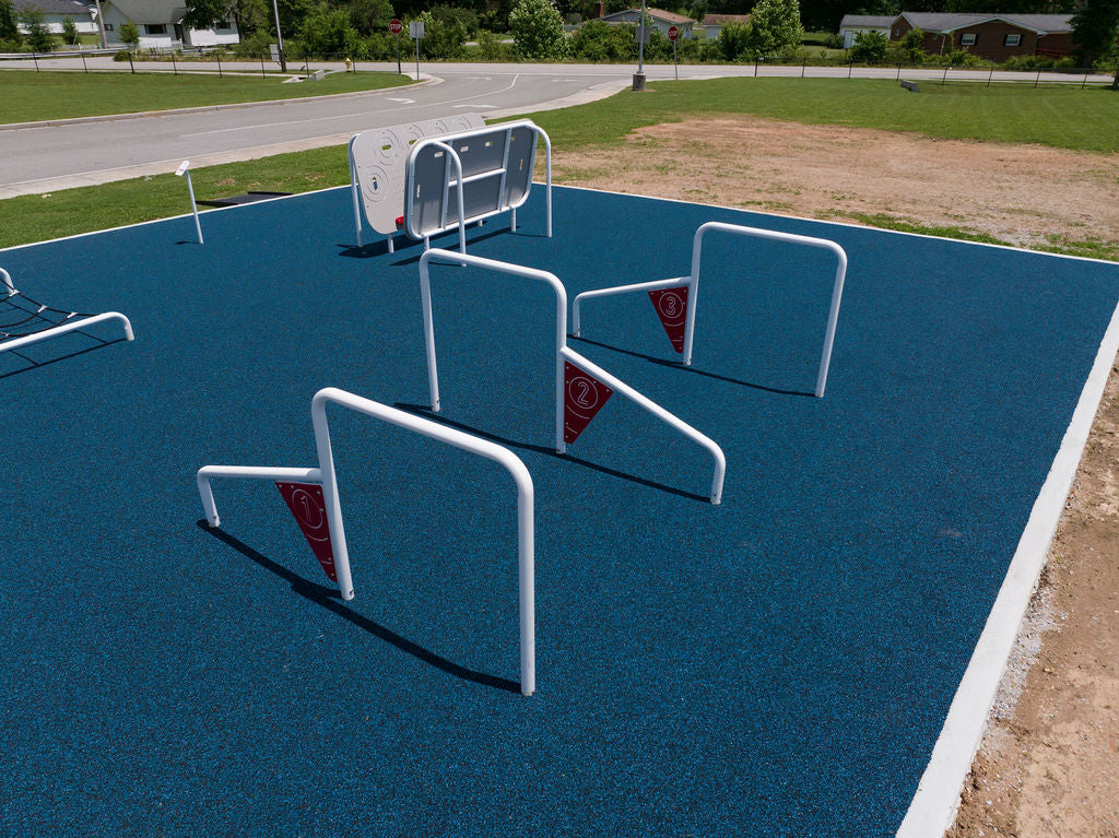 Children playing on the ActionFit Challenge Zone outdoor fitness structure at an elementary school