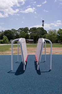 Child using the ActionFit Hero Zone wall-walking fitness station outdoors