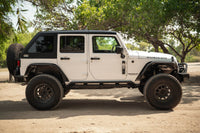 White 2007-2018 Jeep JK 4-Door with DV8 Fastback Hard Top parked on a dirt road
