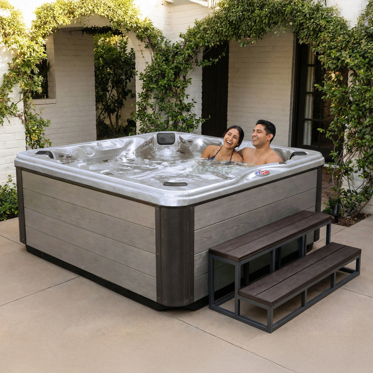 American Spas AMZ745B 7-Person Bench Spa in Limited Edition Platinum interior with Silver Oak cabinet - environment shot
