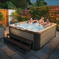 American Spas AMZ756L 6-Person Lounge Spa - Champagne Interior with Silver Oak Exterior in Outdoor Setting