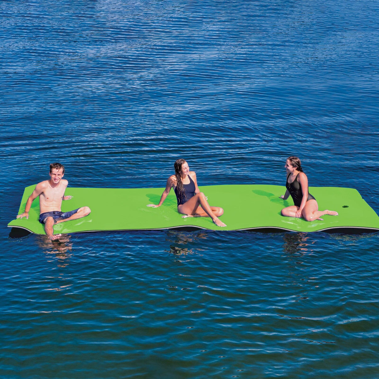 WOW Sports ChillRaft 20x6 ft floating water platform in action on a lake with group of people