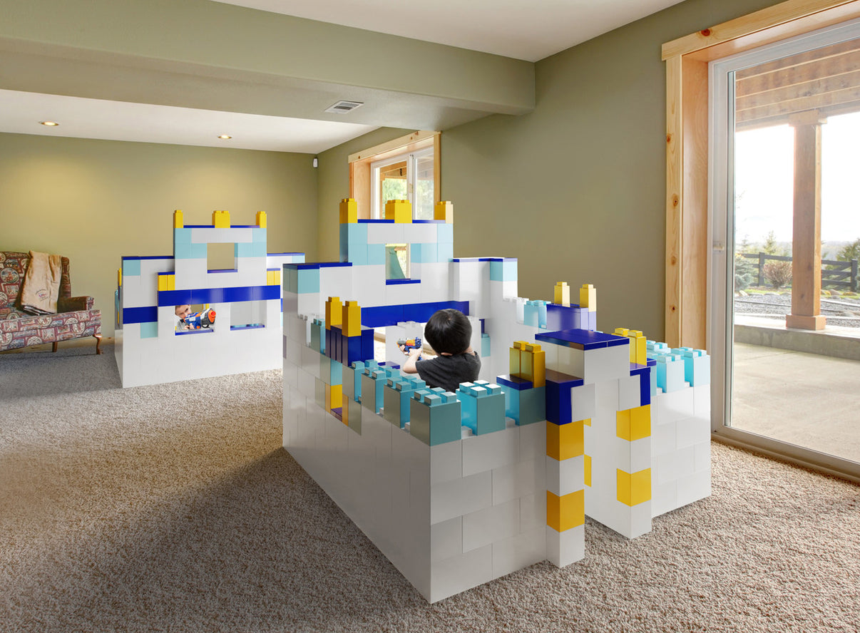 Children and adults building a large walk-in fort with EverBlock modular building blocks