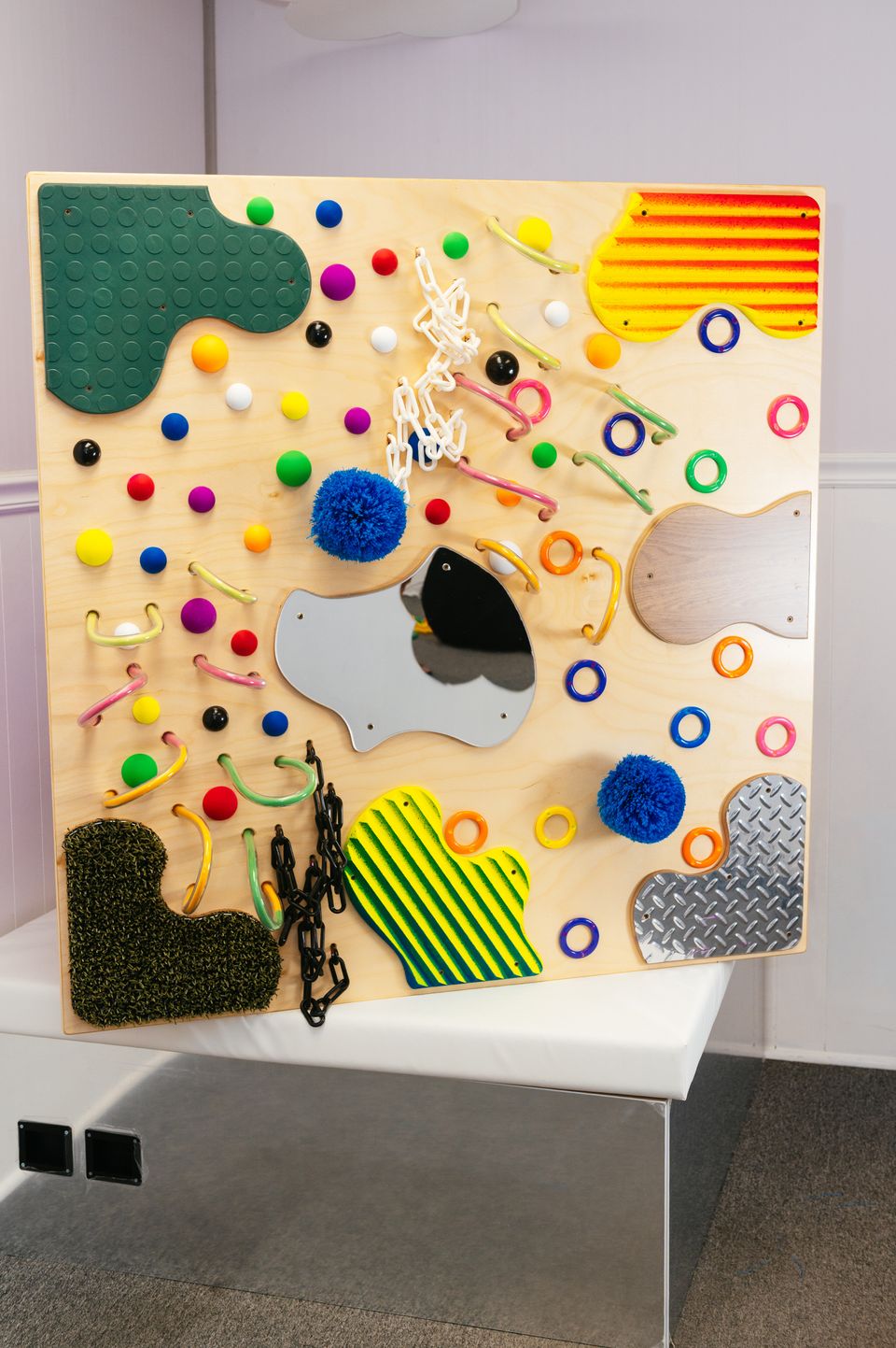 UV Textured Wall sensory panel with 15 glowing textures under UV light - front view