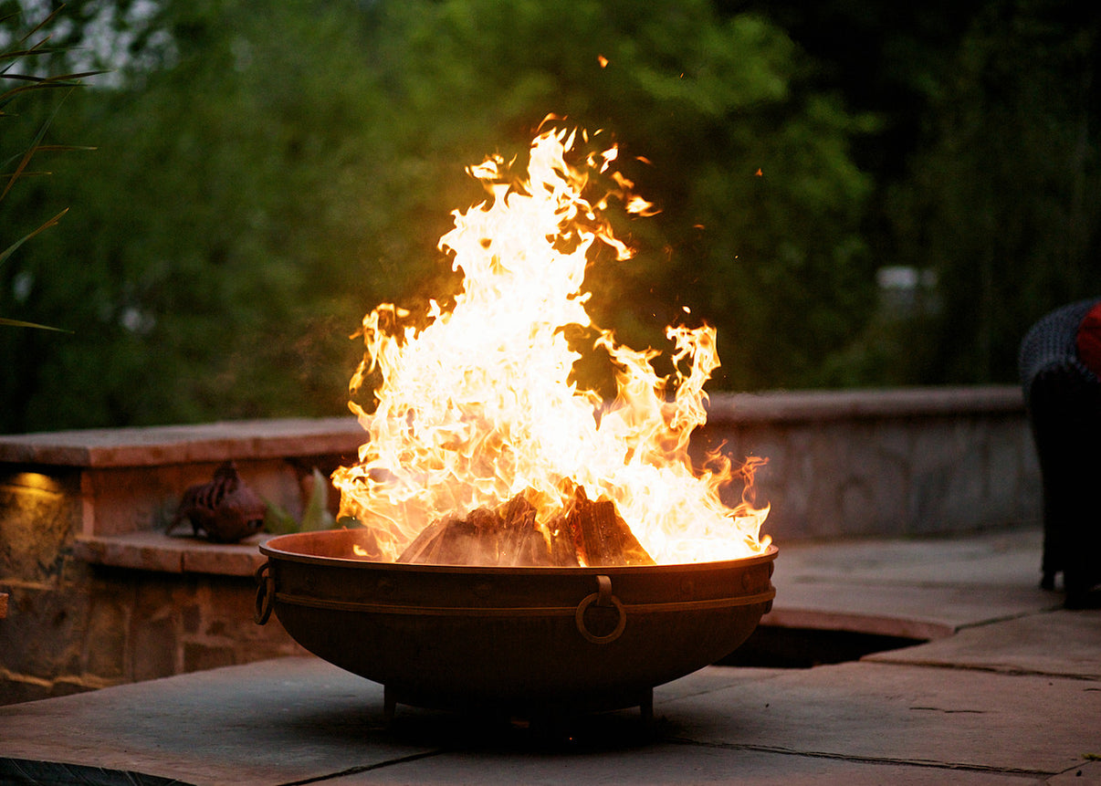 Fire Pit Art Emperor Fire Pit glowing at night with roaring fire