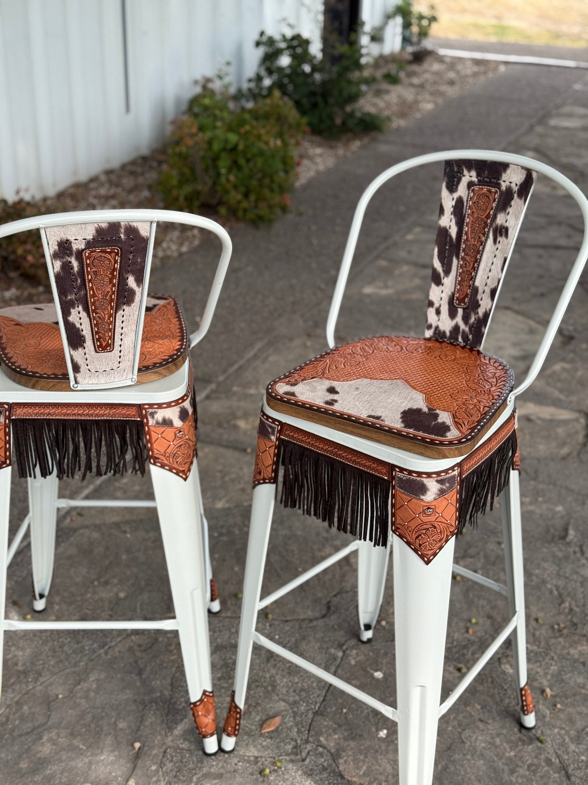 Alamo Saddlery 30-inch white swivel bar stool with hand-tooled leather and cow suede fringe - front view