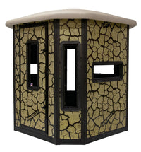 Muddy Bull Steel Box Blind exterior view showing cracked mud pattern and full structure