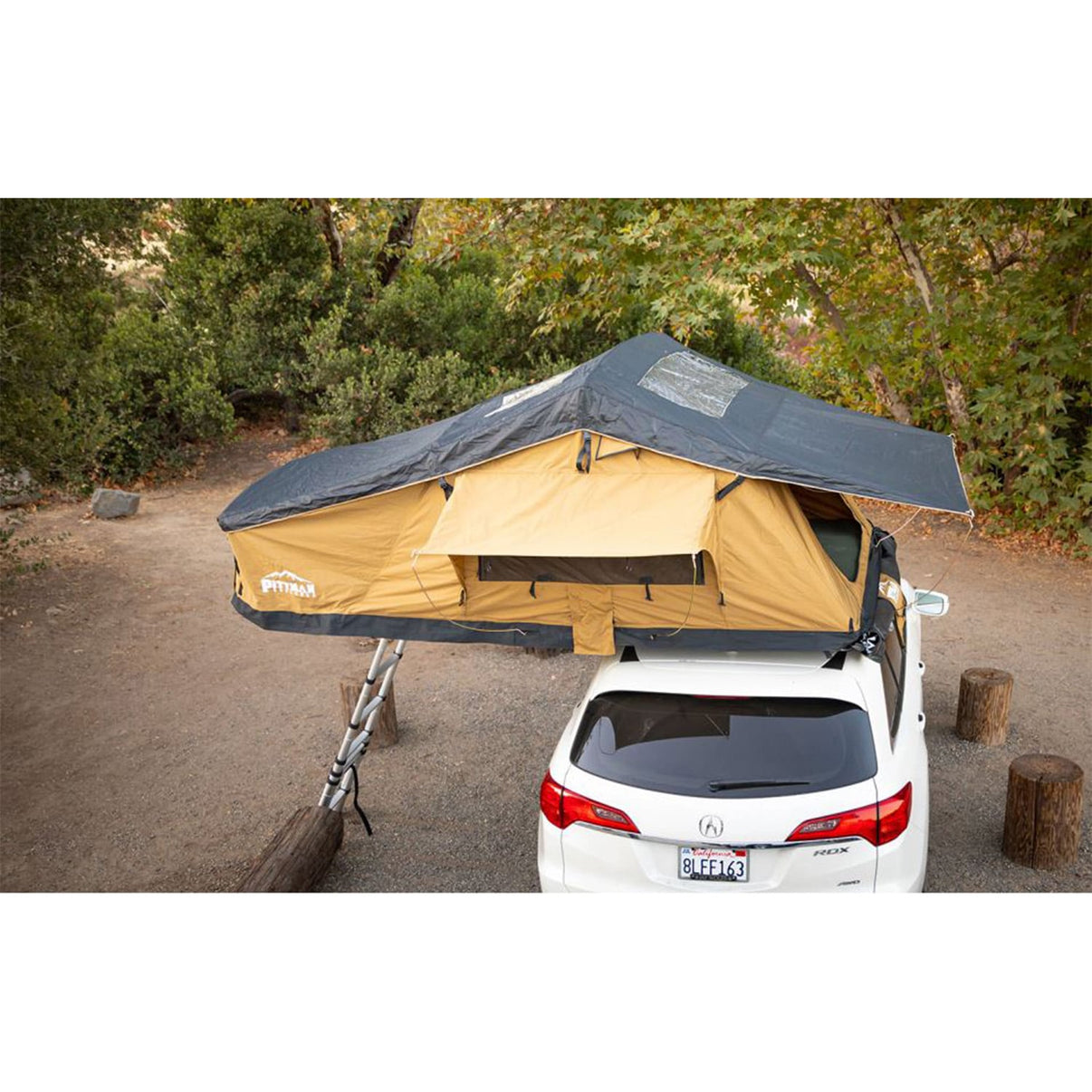 Pittman Outdoors Softshell TNT MAX 1.9 rooftop tent open and deployed on medium SUV in daylight with ladder extended