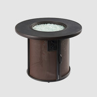 Brown Stonefire Round Gas Fire Pit Table with fire media on burner