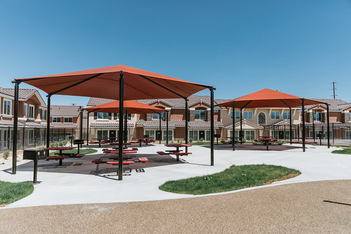 Superior Shade Hexagon Hip Shade installed at Sonoma Apartments CA with outdoor seating area