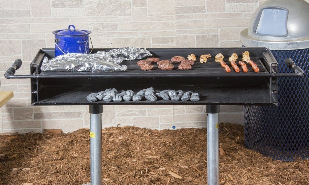 Kay Park XB16 group grill with two pedestal in-ground mount, front angle view showing full cooking surface and black enamel finish