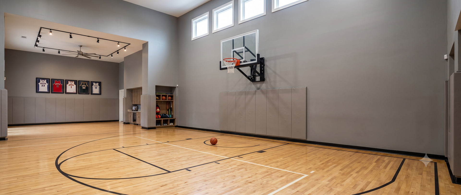 HyperJam wall mount basketball hoop installed on an indoor basketball court