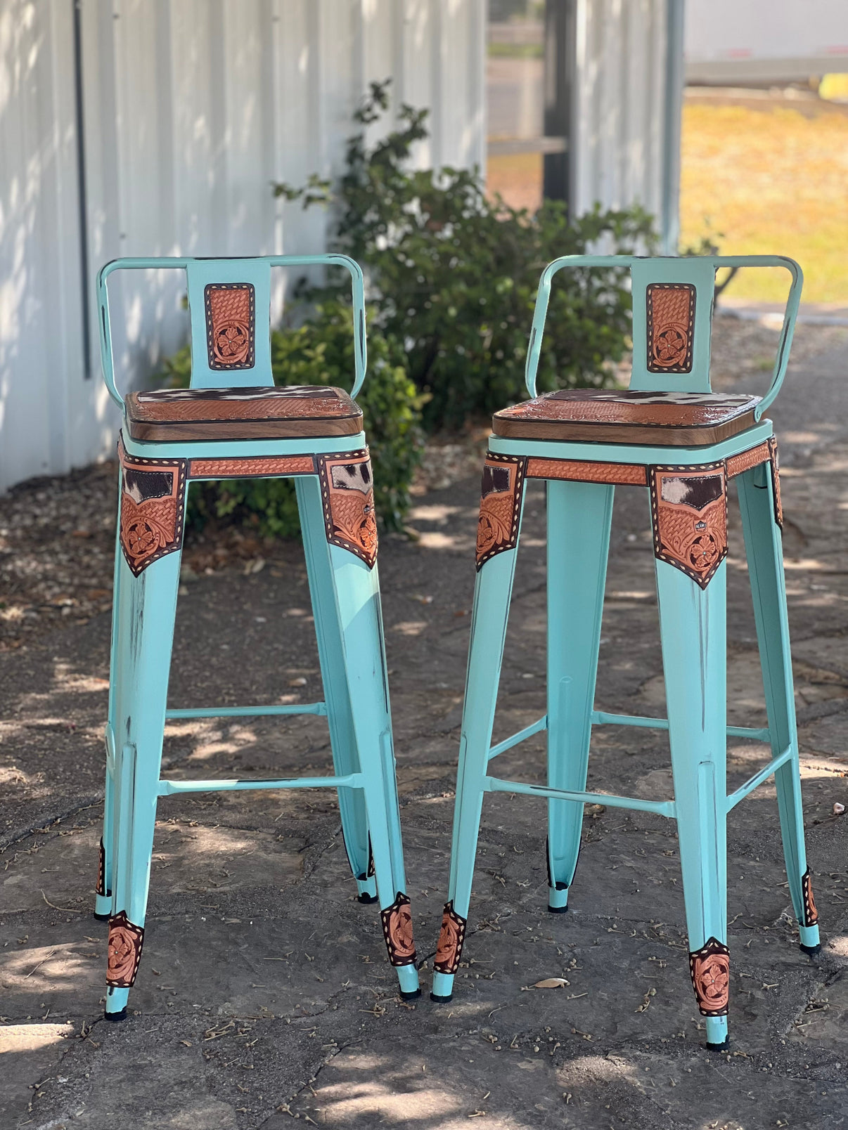 Set of 2 Alamo Saddlery 26 inch turquoise swivel bar stools with cow suede inlay and hand tooled leather - front view