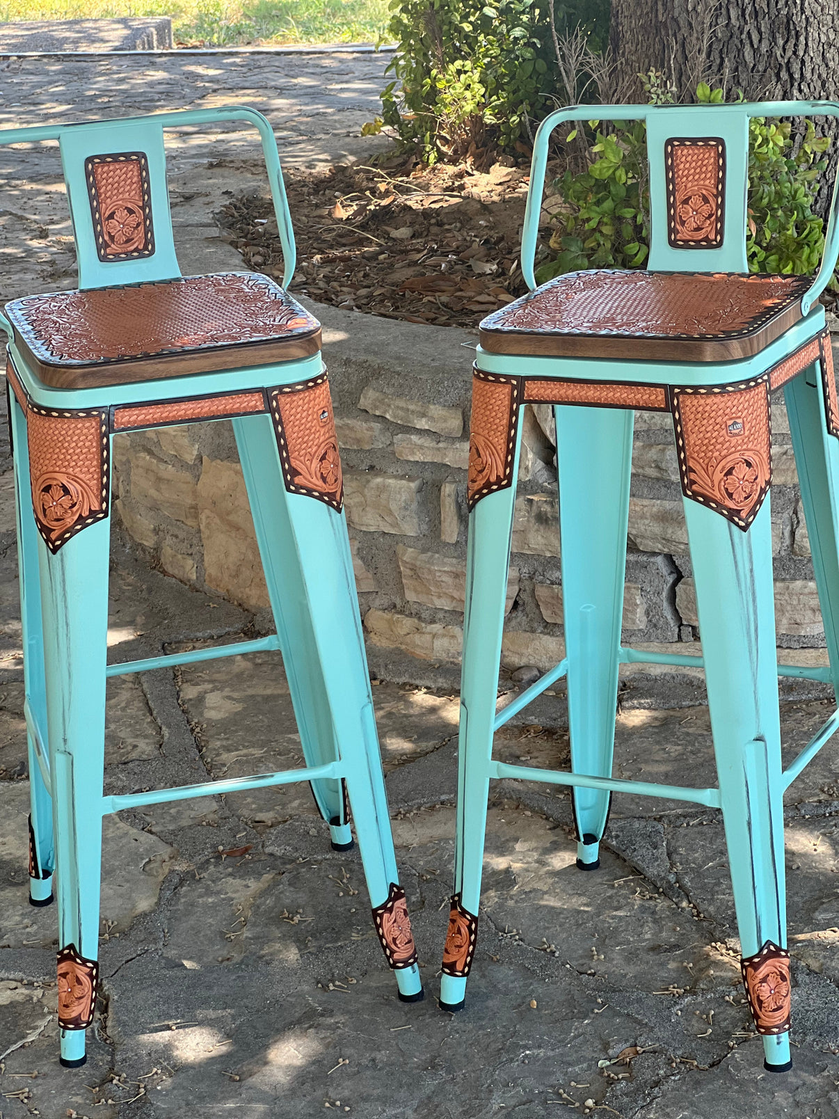 Set of 2 Alamo Saddlery 30-inch turquoise swivel bar stools with golden leather details and chocolate edge paint