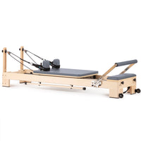 Elina Pilates Lignum Wooden Reformer - full view, maple wood frame with grey upholstery