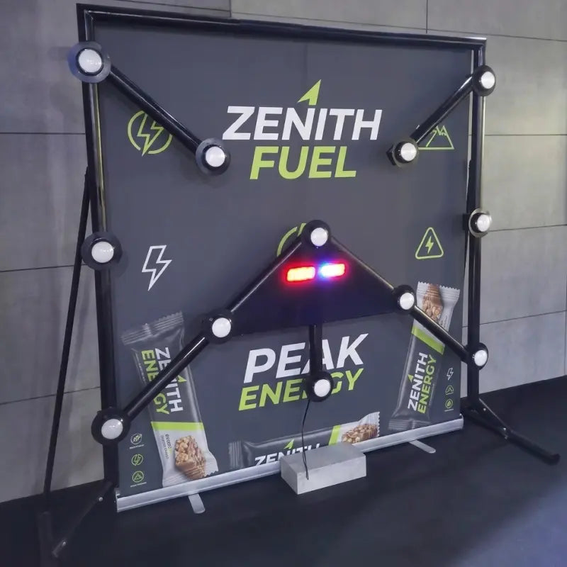 Strike-a-Light Batak speed reaction game with branded banner at trade show event